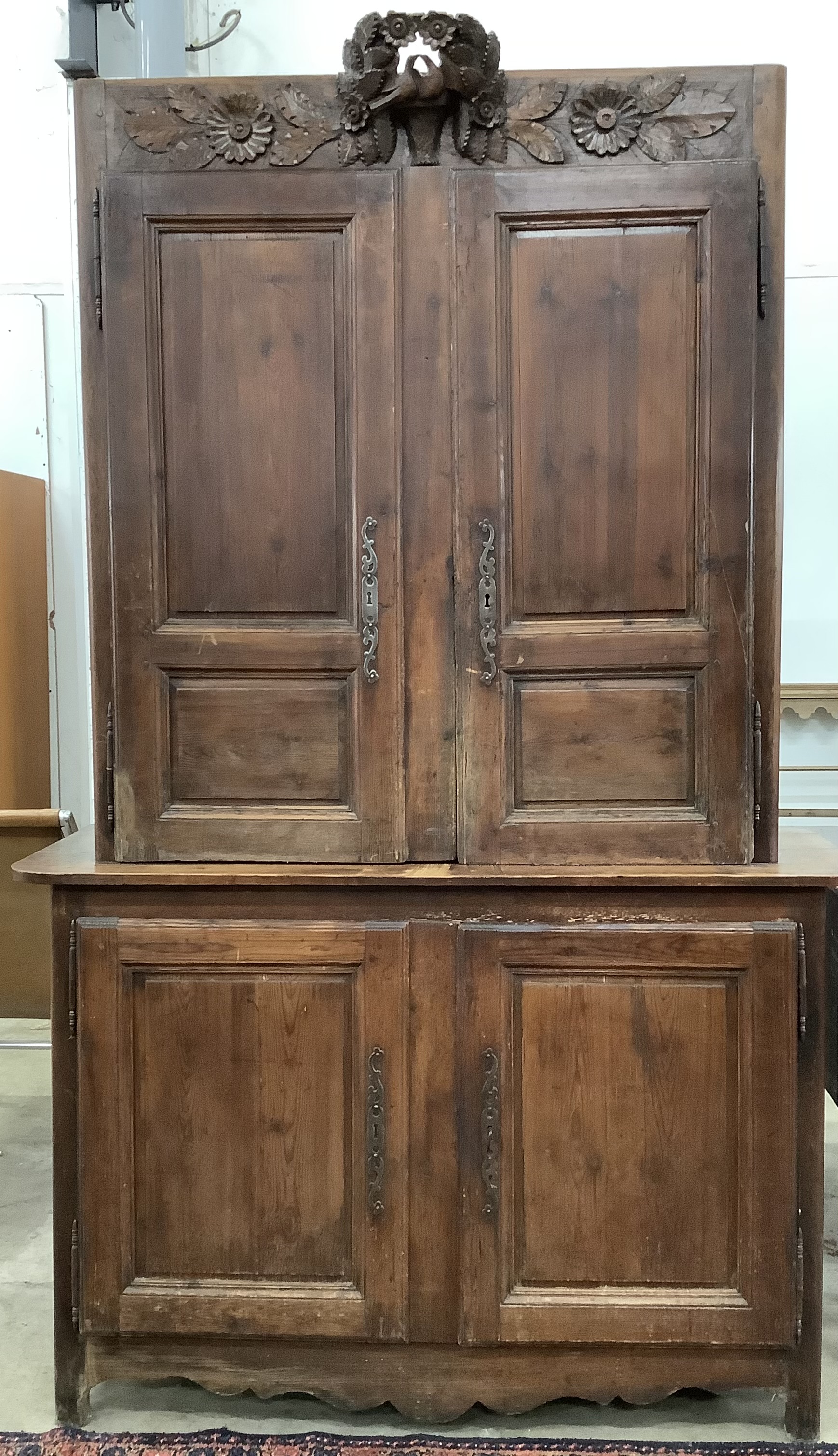 A 19th century Normandy pine marriage cupboard in two parts and carved with birds, width 141cm, depth 53cm, height 228cm